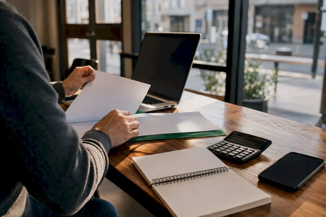 Hands organizing ITIN loan documents