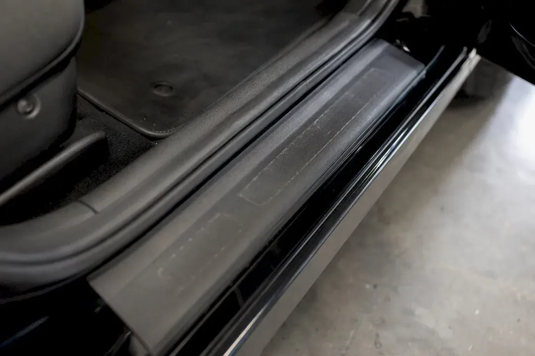 Car door sill with aftermarket trim protector