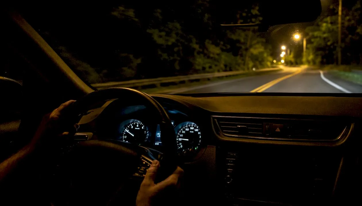 Car dashboard glowing during night drive